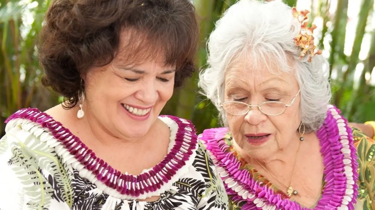 Two smiling women wearing lei